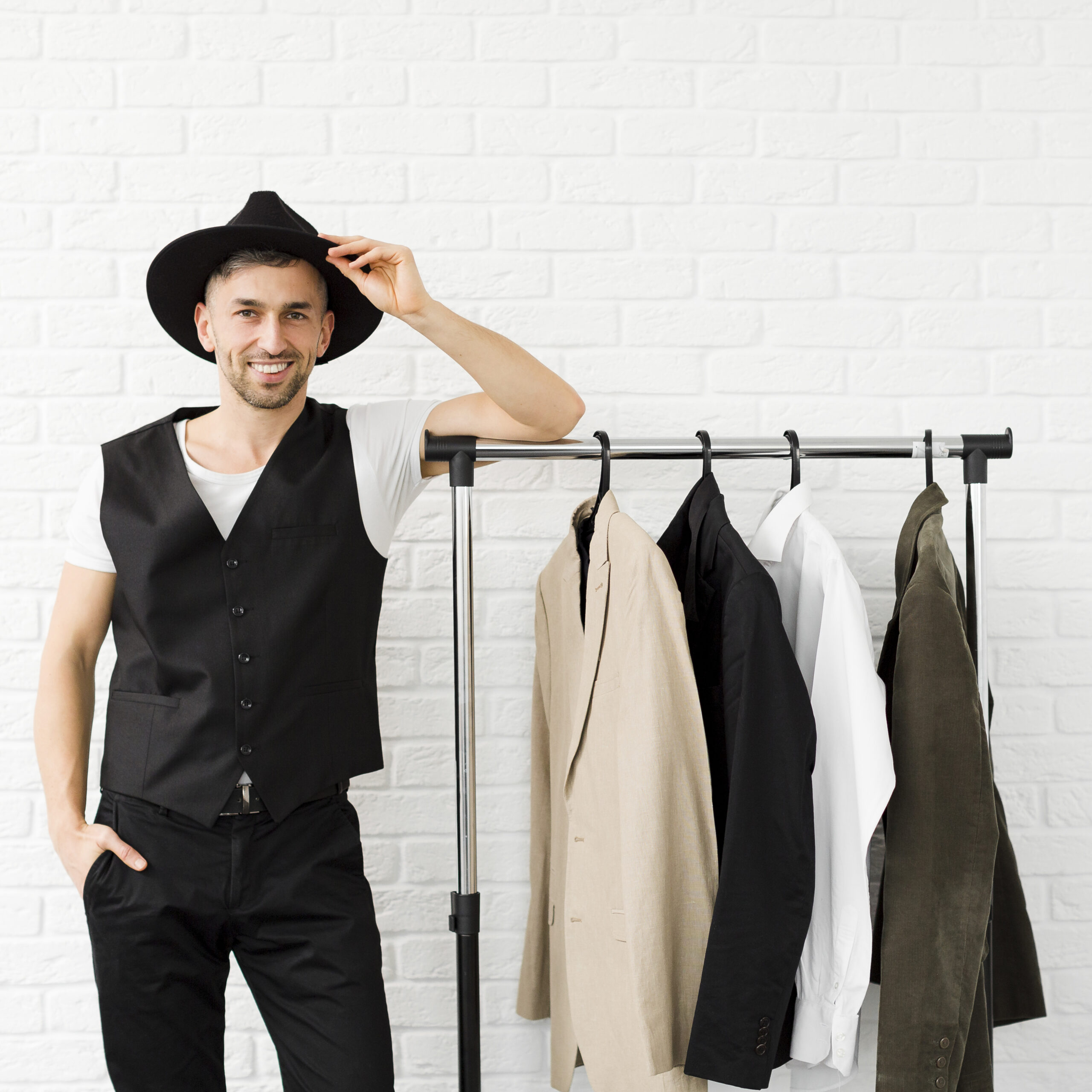 stylish man wearing hat standing wardrobe
